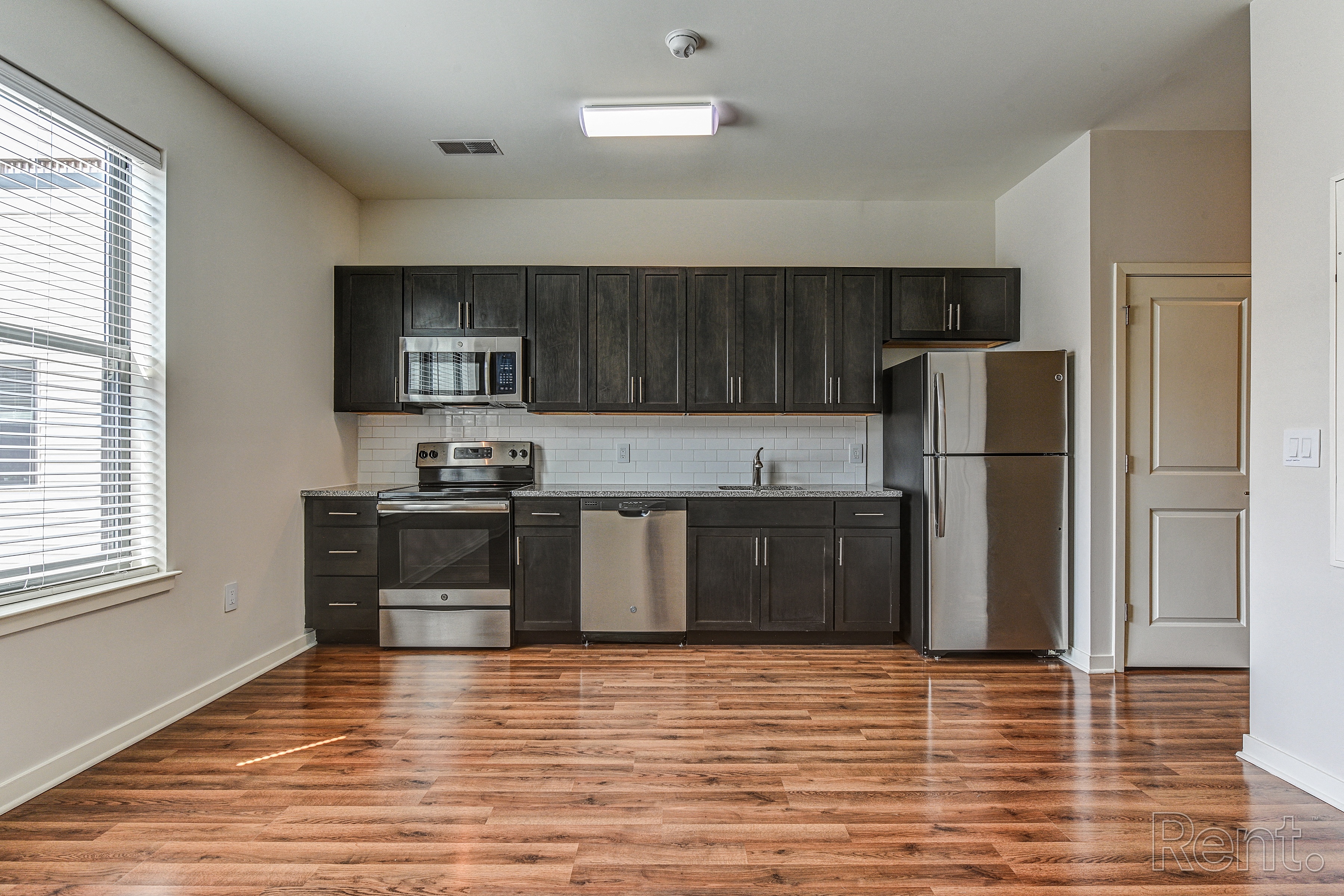 Kitchen with dark wood cabinets and stainless steel appliances  at The View at Old City, Philadelphia