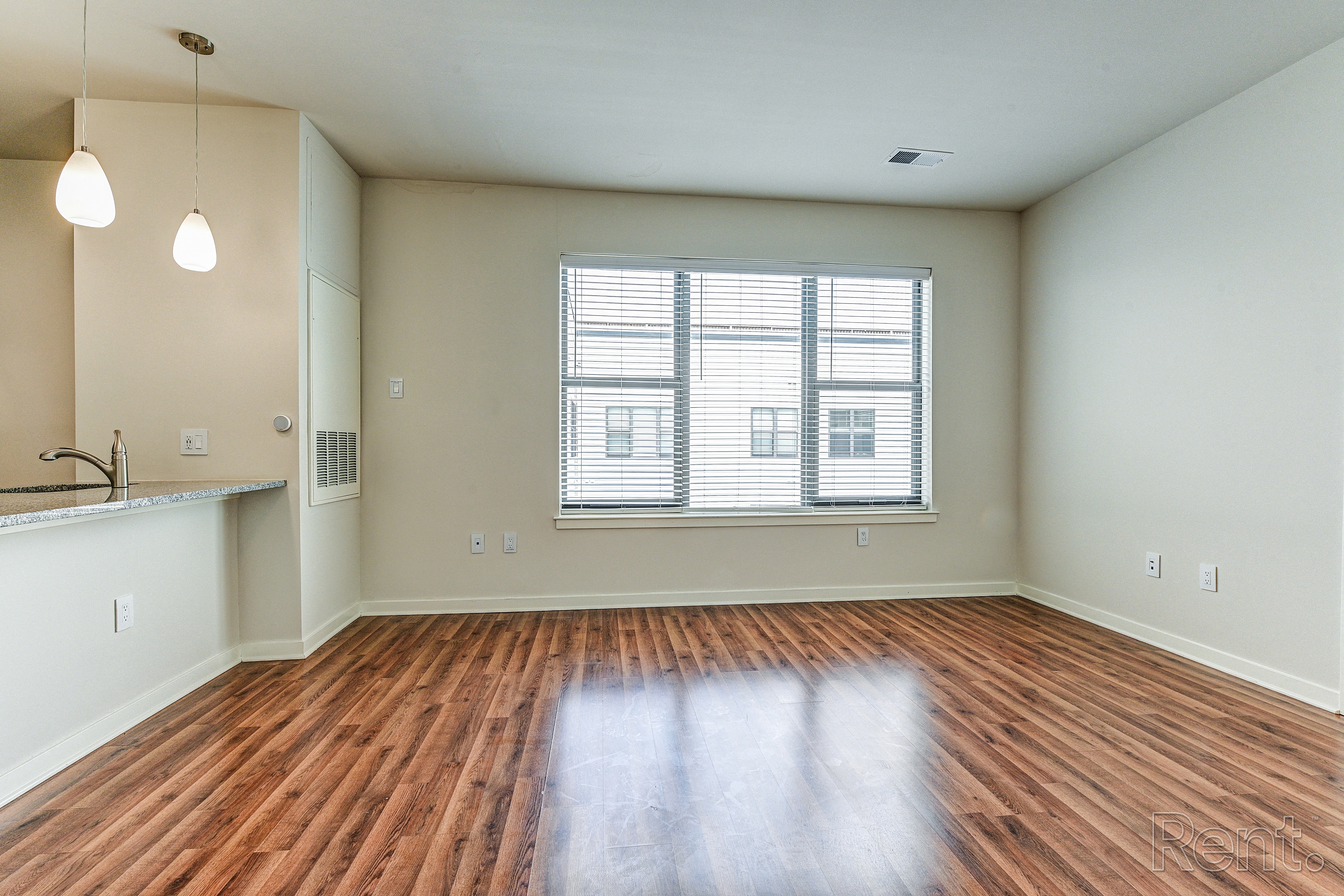 Kitchen and living room with hardwood floors and a large window  at The View at Old City, Philadelphia