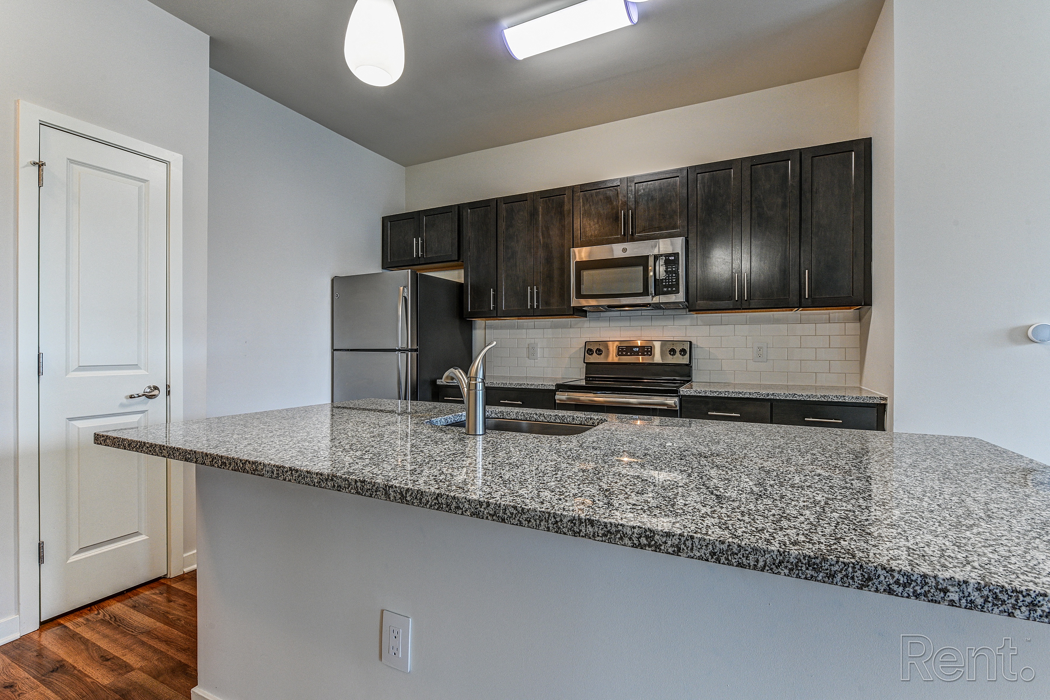 Kitchen with granite countertops and dark wood cabinets  at The View at Old City, Philadelphia