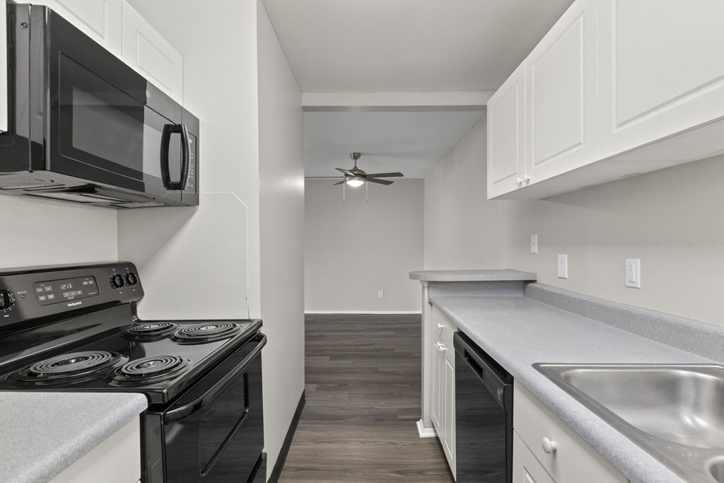 Kitchen with white cabinets and a black stove top oven at Creve Coeur, Creve Coeur, MO