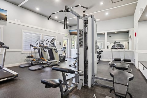 A gym with a variety of equipment including treadmills, weights, and exercise machines. at Deer Crest Apartments, Broomfield