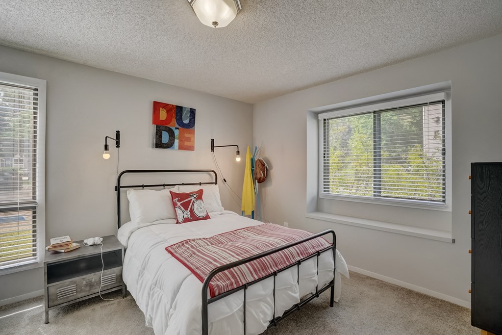 Bedroom with a bed and two windows at Governor's Park, Fort Collins, 80525