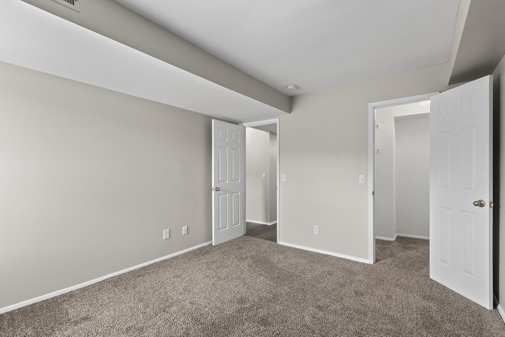 Bedroom with a carpeted floor and two doors at Creve Coeur, Creve Coeur, MO