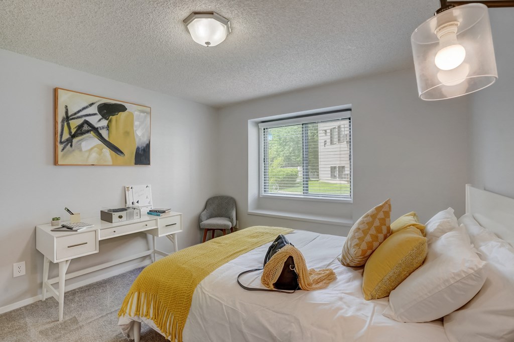 Bedroom with a large bed and a desk at Governor's Park, Fort Collins, 80525