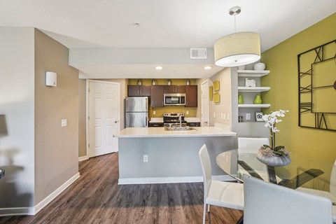 A modern kitchen with a dining table and chairs.