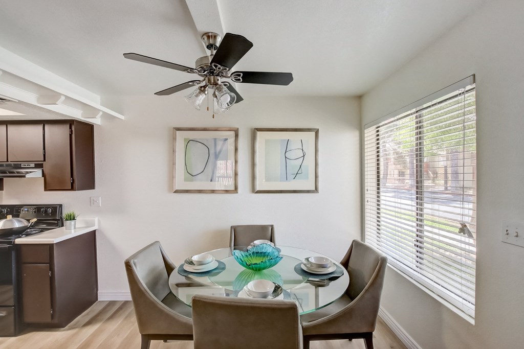 Dining Area with a Glass Table a dining area with a glass table and chairs and a ceiling fan at Glen at Mesa Apartments, AZ 85201
