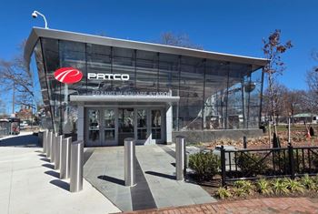 The Patco building has a glass facade and a red logo. at The View at Old City, Philadelphia