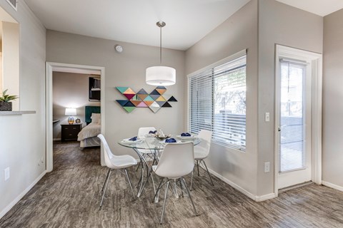 A dining room with a white table and chairs at Sweetwater At Metro North Apartments, Phoenix, AZ