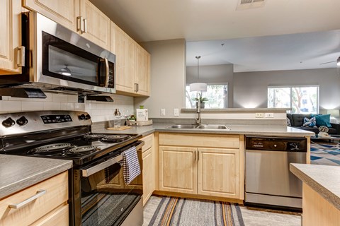 A kitchen with wooden cabinets and stainless steel appliances.