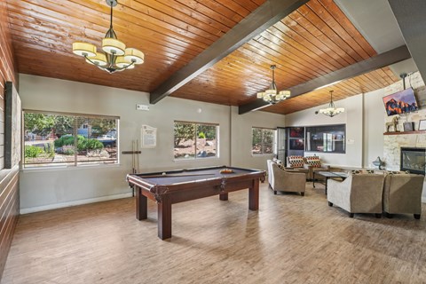 A room with a pool table and a billiard table.