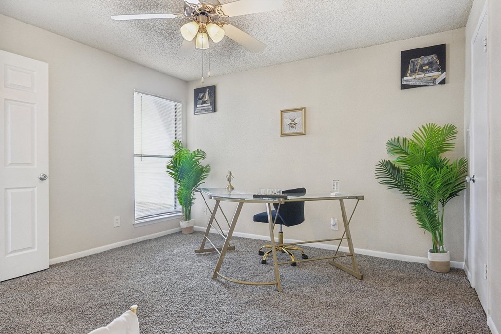 a home office with a desk and a ceiling fan at The Glen at Highpoint, Dallas, 75243