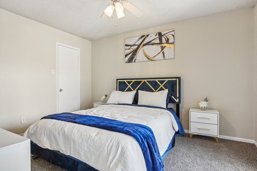 a bedroom with a bed and a ceiling fan at The Glen at Highpoint, Dallas, 75243