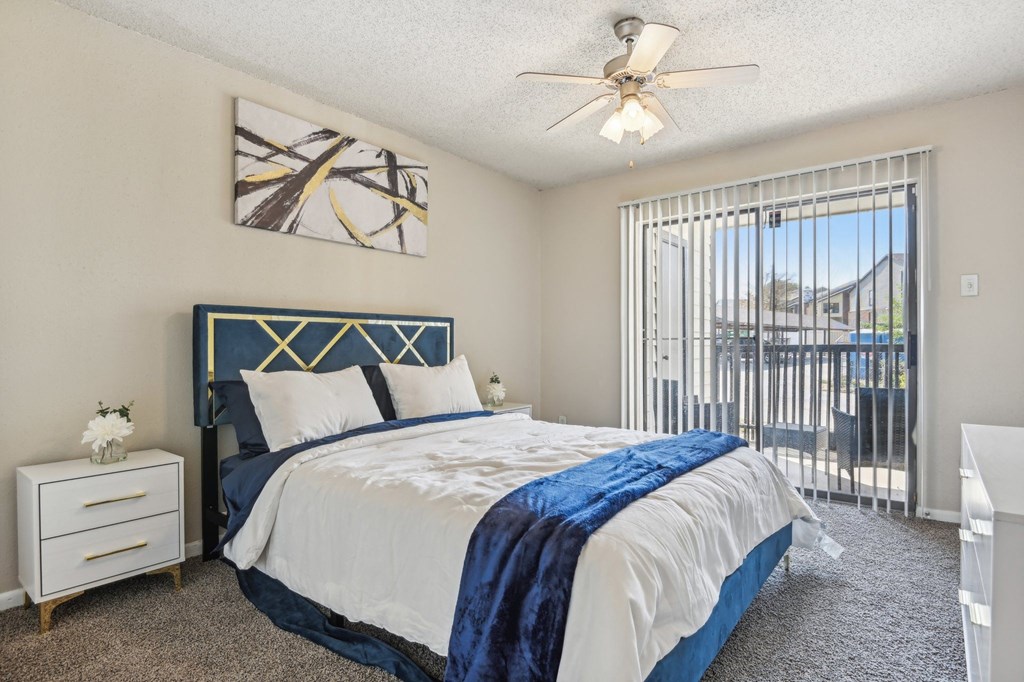 a bedroom with a bed and a ceiling fan at The Glen at Highpoint, Dallas, 75243