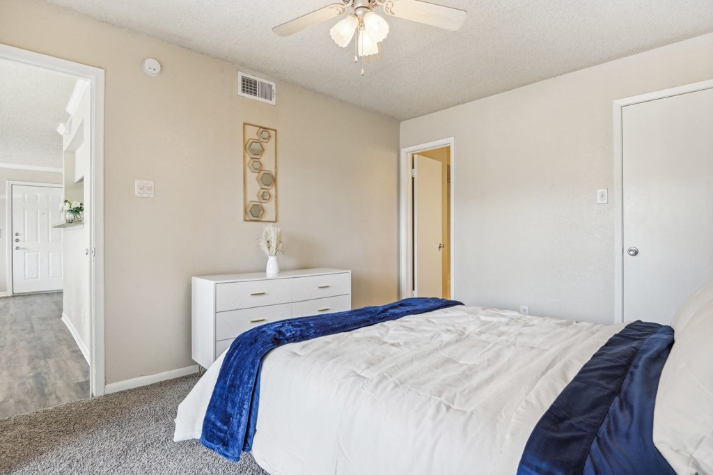 a bedroom with a bed and a ceiling fan at The Glen at Highpoint, Dallas, 75243