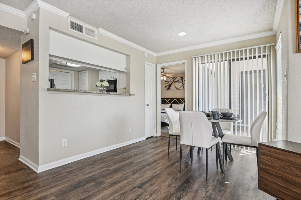 a living room and dining room with a table and chairs at The Glen at Highpoint, Dallas, 75243