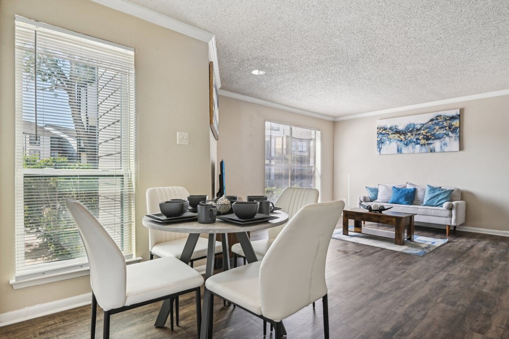 a dining room with a table and chairs and a window at The Glen at Highpoint, Dallas, 75243