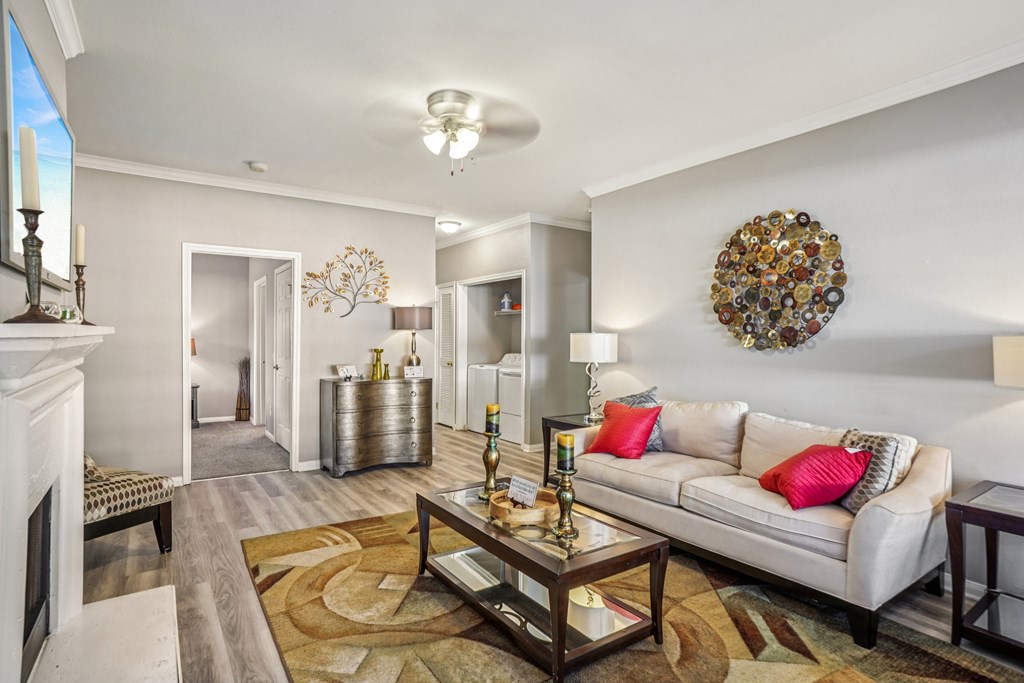 A living room with a white couch and a coffee table.