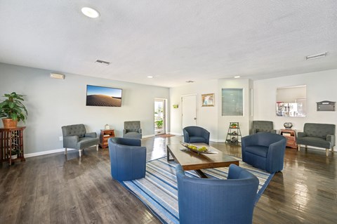 A living room with a blue couch and a wooden coffee table.