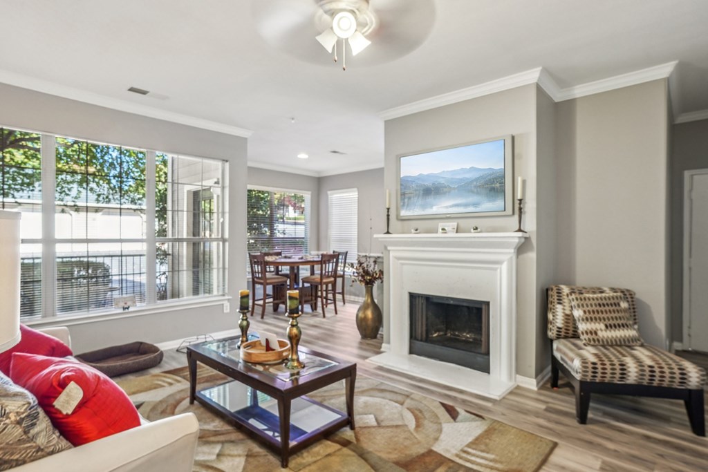 A living room with a fireplace and a painting on the wall.