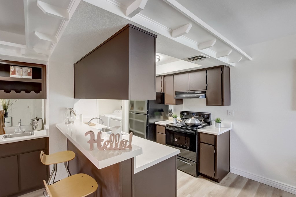 a kitchen with brown cabinets and white countertops at Glen at Mesa Apartments, AZ 85201