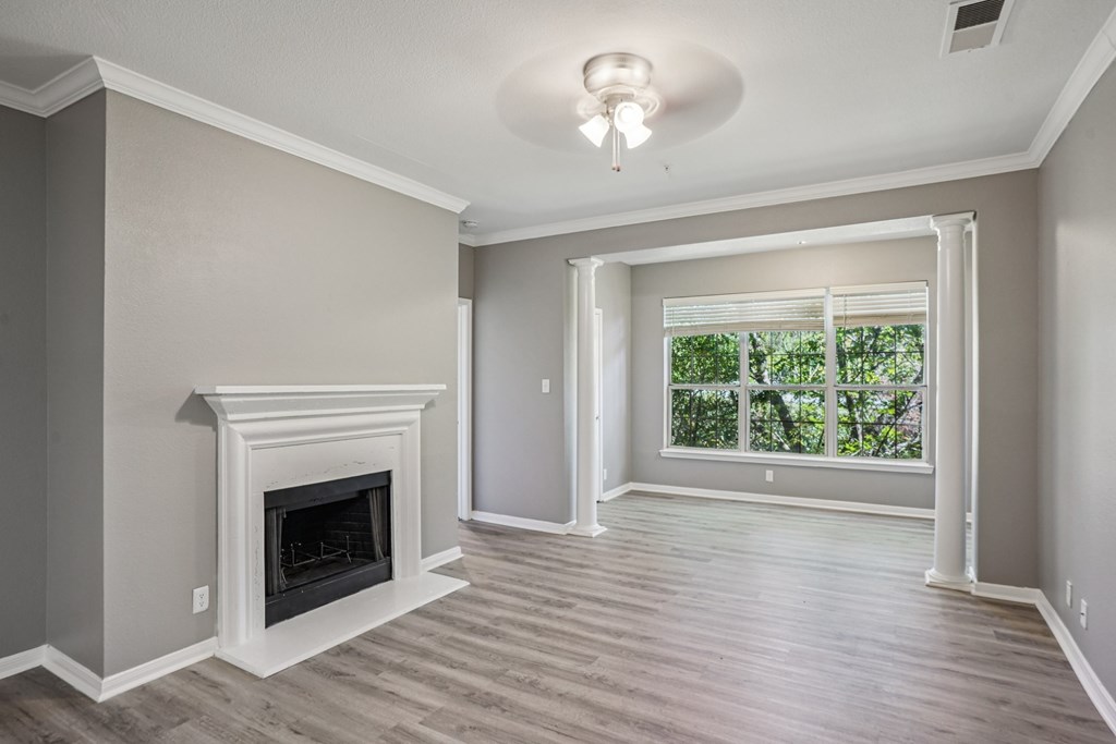 A room with a fireplace and sliding glass doors.