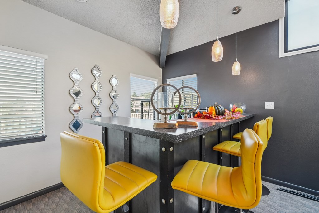 A kitchen with a table and chairs.
