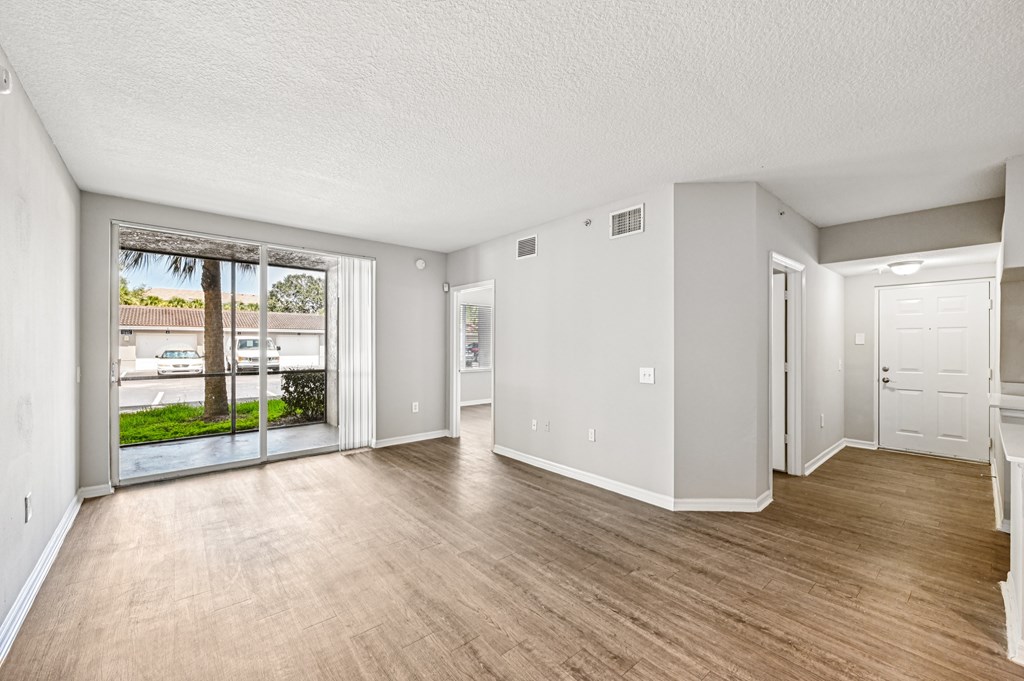 A spacious room with wooden flooring and white walls. at Heritage Bay, Jensen Beach