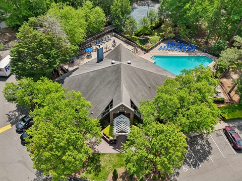 A large building with a pool in front of it.