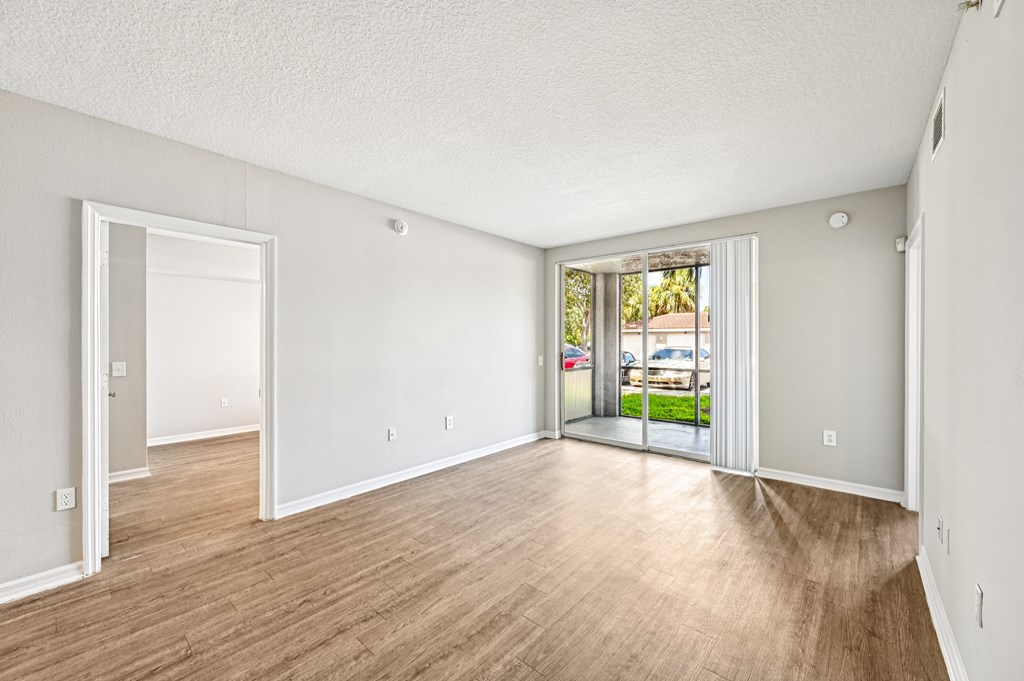 A room with a sliding glass door leading to a balcony. at Heritage Bay, Jensen Beach, FL