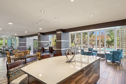 A large dining room with a long table and chairs.