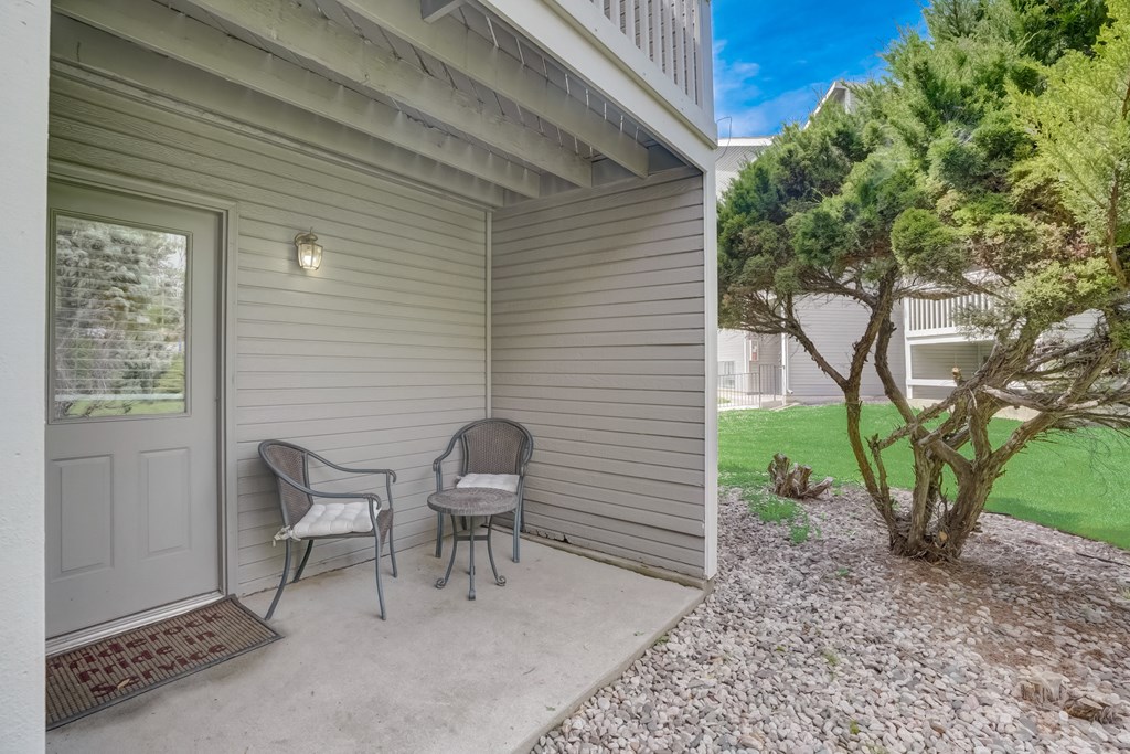 Patio with two chairs and a tree in the background at Governor's Park, Fort Collins, 80525