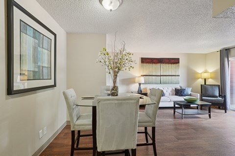 A dining room with a table set for four.