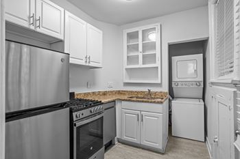 A kitchen with a stove, oven, and refrigerator.