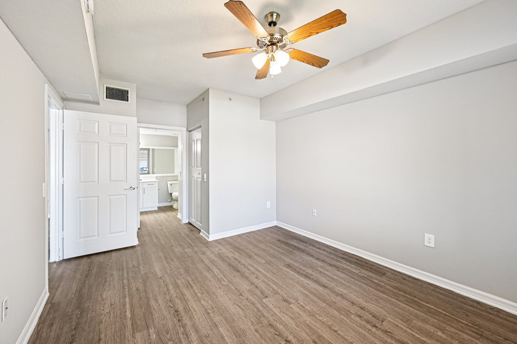 A room with a ceiling fan and light fixture, and a hardwood floor. at Heritage Bay, Jensen Beach, FL, 34957