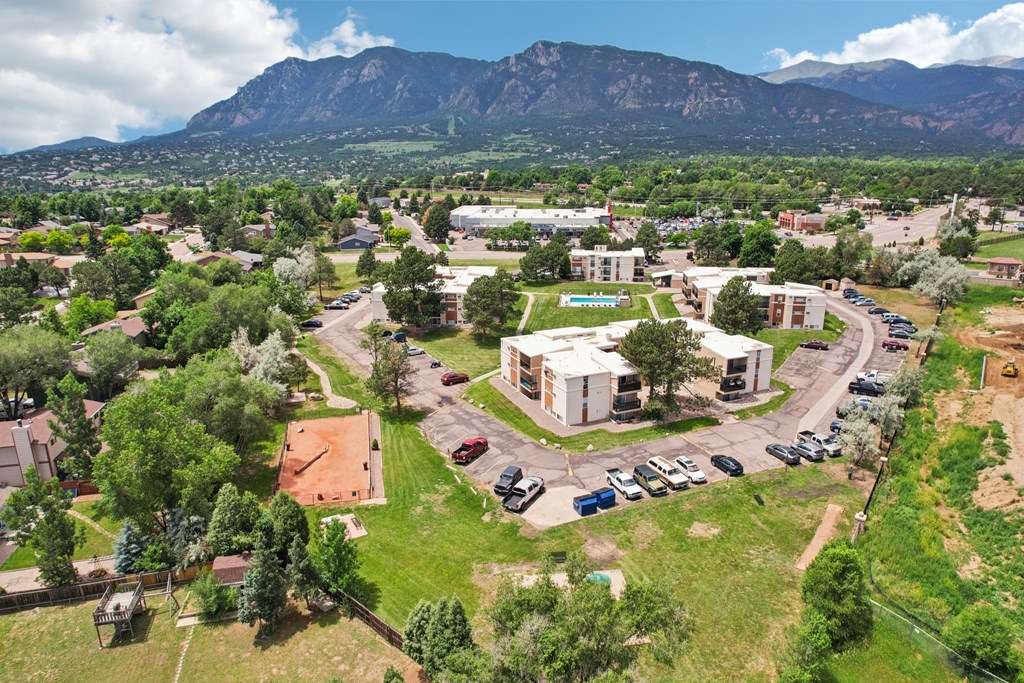 A bird's eye view of a small town with a large mountain in the background.