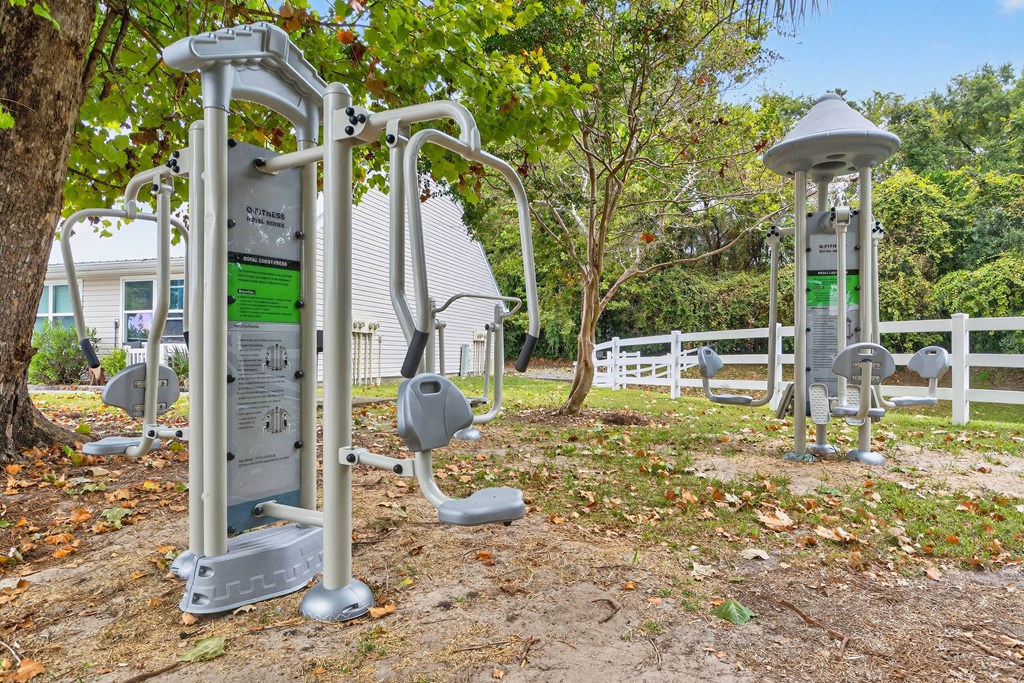 A set of outdoor exercise equipment is located in a park.at Lofts of Wilmington, Wilmington, North Carolina