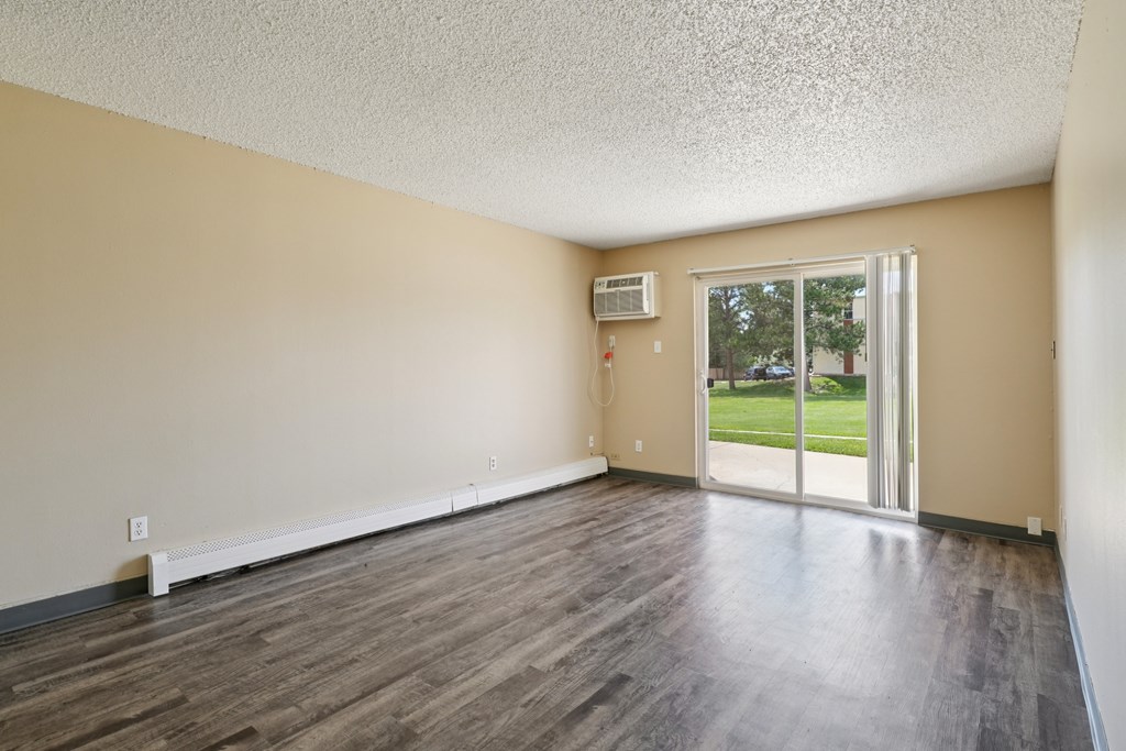 A room with a sliding glass door leading to a backyard. at Broadmoor Springs, Colorado