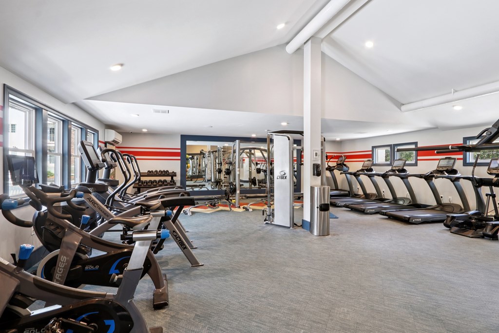 A gym with treadmills and exercise equipment. at Heritage at the River, Manchester, NH