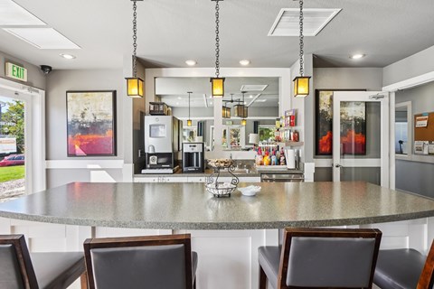 A kitchen with a table and chairs in front of it. at Deer Crest Apartments, Broomfield, 80020
