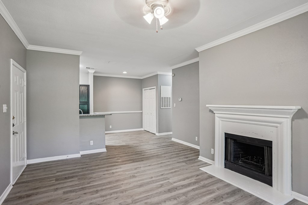 A living room with a fireplace and a ceiling light.