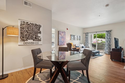 A dining room with a glass table and chairs.