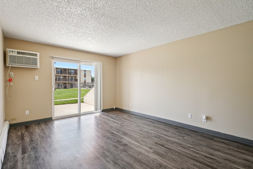 A room with a sliding glass door leading to a balcony. at Broadmoor Springs, Colorado Springs, Colorado