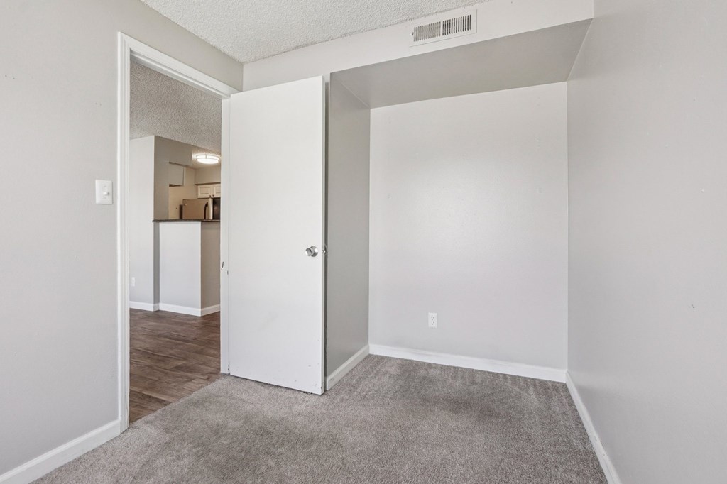 A white door is open to a hallway.