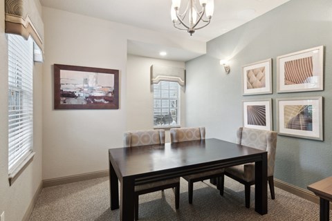 A dining room with a table and chairs.