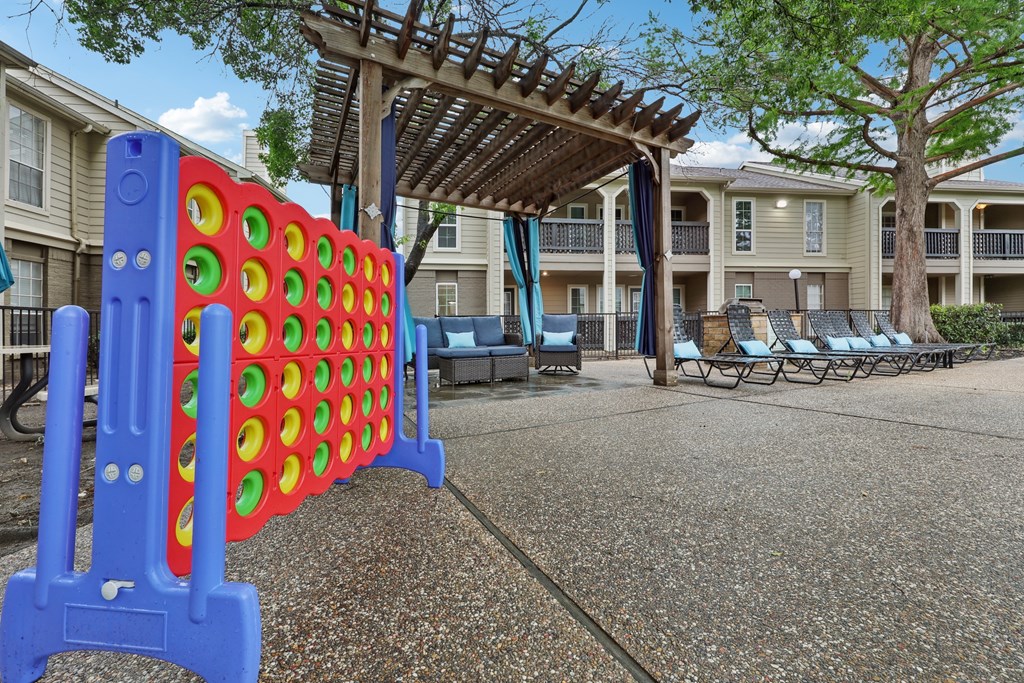 A large blue and red foosball table in the middle of a courtyard at The Willows on Rosemeade, Dallas, TX 75287
