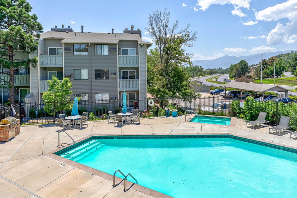 Swimming pool and a patio with chairs  at Union Heights Apartments, Colorado Springs, CO