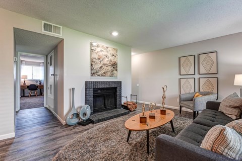 Living room with a fireplace and a table  at Union Heights Apartments, Colorado Springs, CO