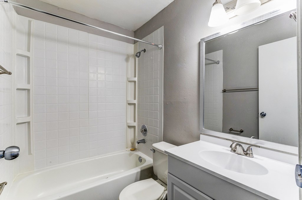 Bathroom with a sink and a tub and a mirror  at Union Heights Apartments, Colorado Springs, CO