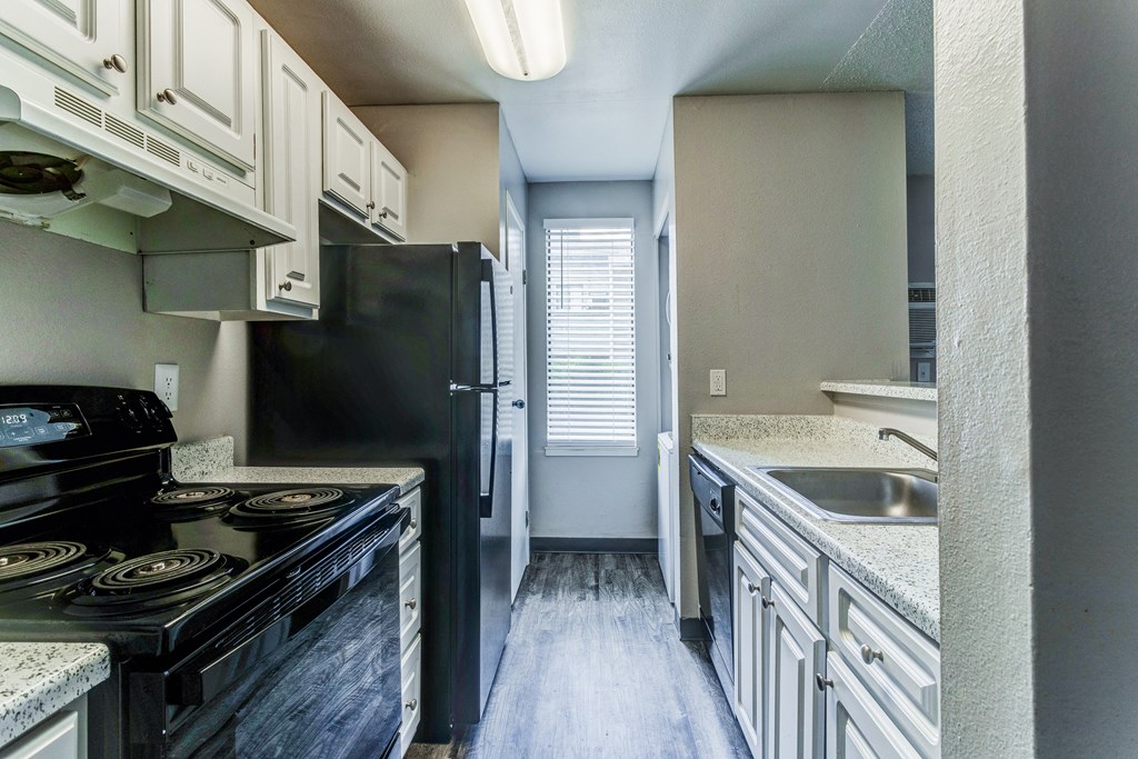 Empty kitchen with black appliances and white cabinets  at Union Heights Apartments, Colorado Springs, CO