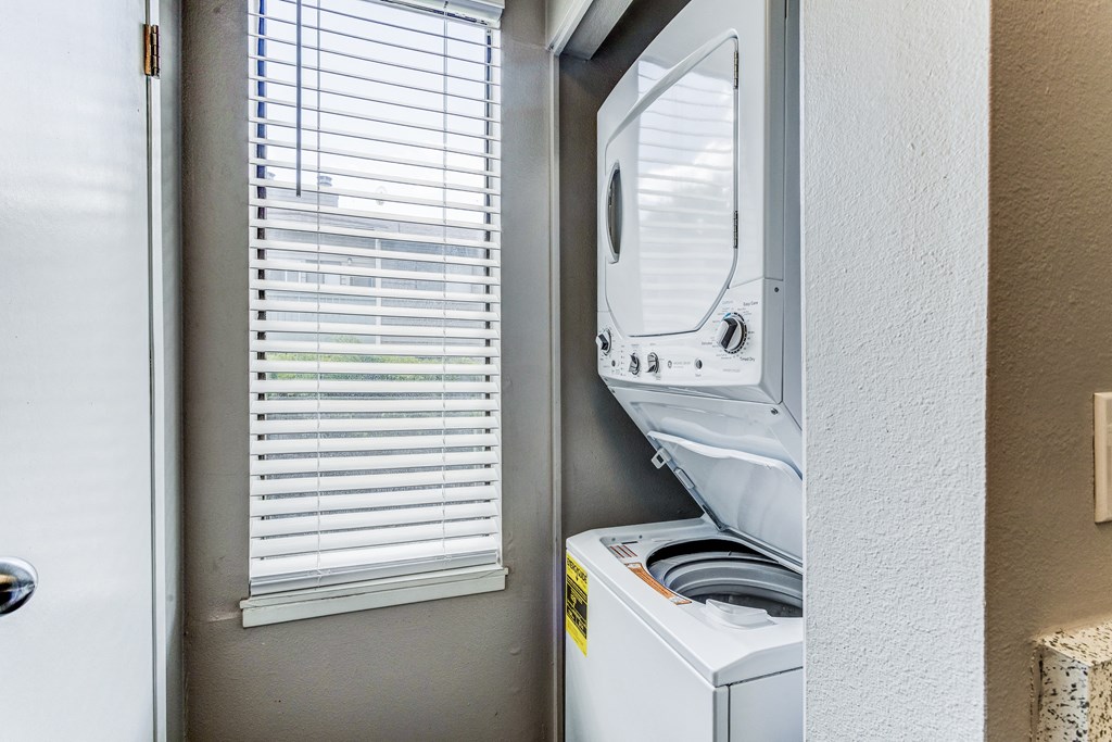 Laundry room has a washer and dryer and a window at Union Heights Apartments, Colorado Springs, CO